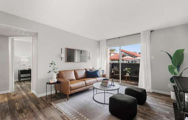 A living room with a brown leather couch and a coffee table.