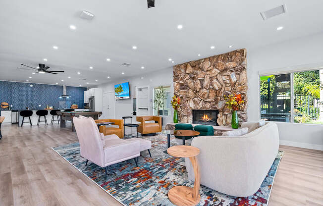 A living room with a stone fireplace and a large couch.