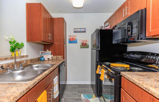 a modern kitchen with stainless steel appliances and wooden cabinets