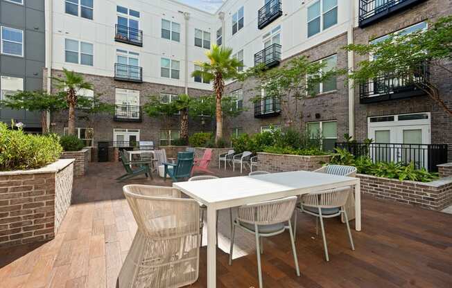 an outdoor patio with tables and chairs in an apartment building