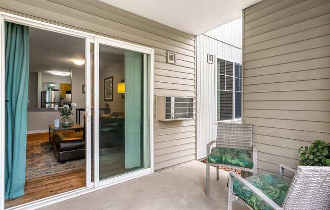 A patio with a chair and a table.