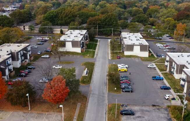 an aerial view of a neighborhood of houses and cars parked