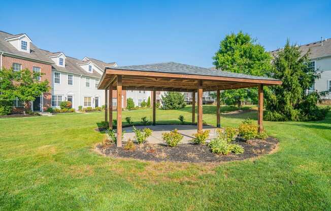a gazebo in the middle of a yard with houses in the background at Traditions at Slate Ridge, Ohio