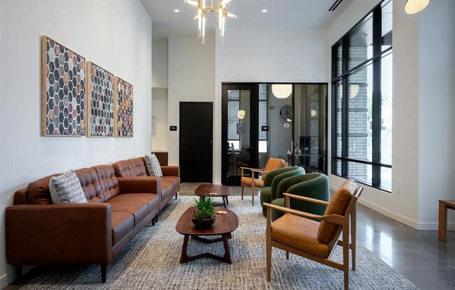 a living room with a couch and chairs and a rug