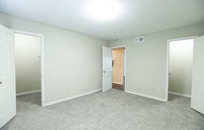 A large bedroom with walk in closets at Willow Creek Apartments, Texas