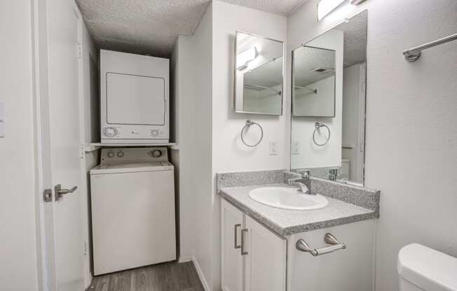a bathroom with a sink and a washing machine