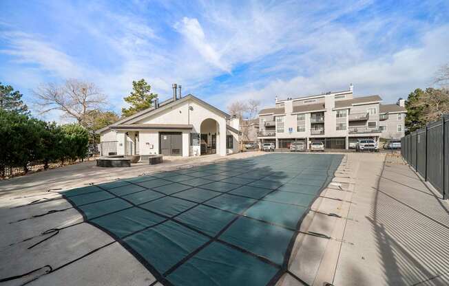 A parking lot with a building in the background.