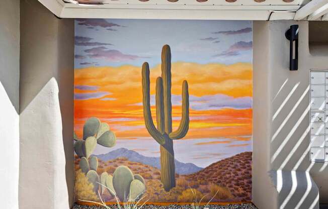 A desert scene with a cactus in the foreground.
