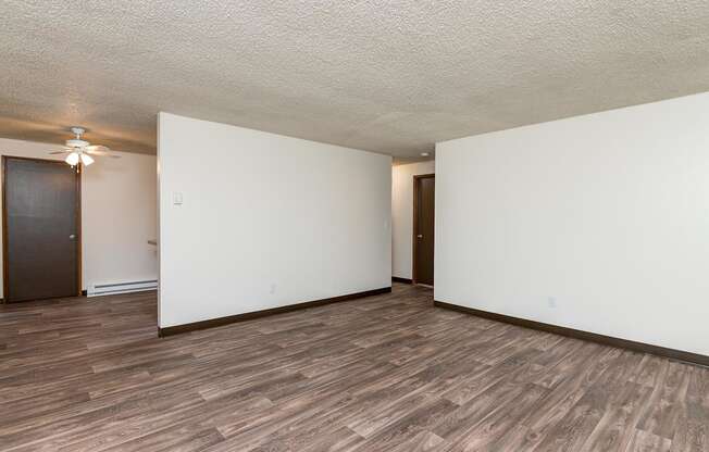 Pinewood Terrace Apartments | Living Room open to dining room and hallway.