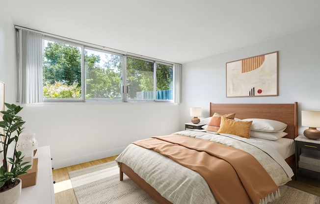 Studio, 1, & 2-BR Apartments in Redwood City, CA - Avenue Two - Bedroom with Hard Surface Flooring, Windows, a Rug, and Stylish Decor at Avenue Two Apartments, Redwood City  , CA 94063