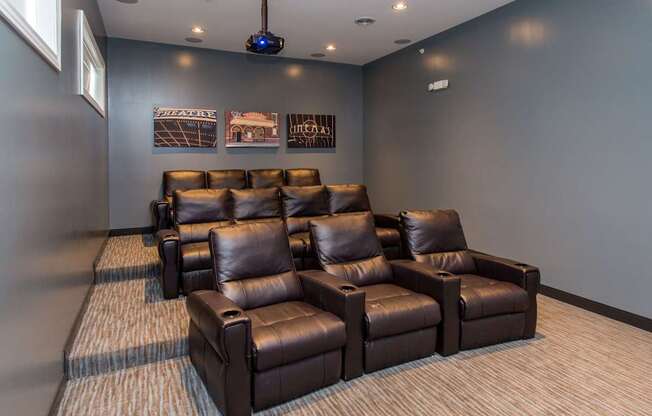 a large media room with leather couches and chairs at The Winhall of Williams Pointe Apartments, IOWA, 50263
