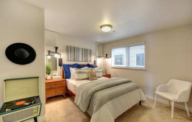 Bedroom with Window with Wood Frame Bed, Carpet, Record Player and Window