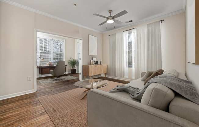 a living room with a couch and a ceiling fan