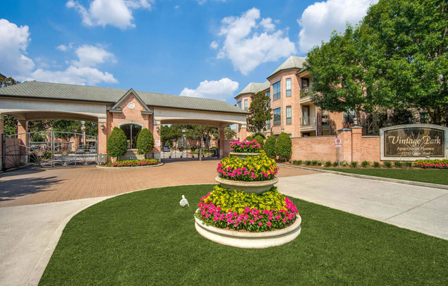 the view of the courtyard with a flower arrangement in front of a building