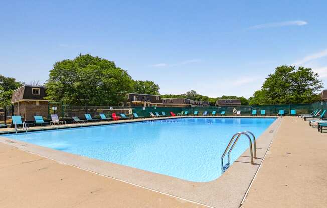 Swimming pool with new seating area and lounge chairs at Aspen Ridge Apartments in West Chicago Illinois 60185