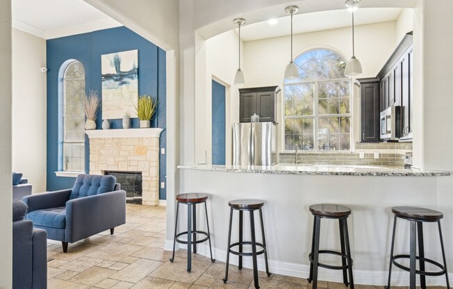 a living room with a bar and a fireplace