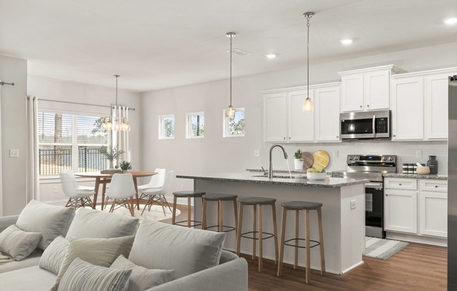 an open kitchen and living room with a couch and a table