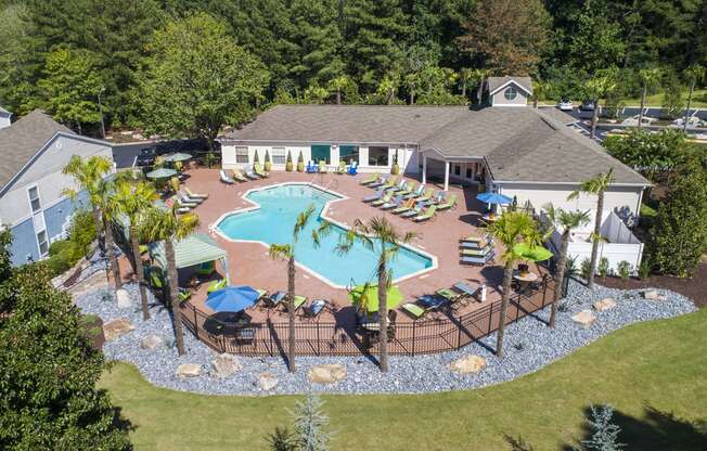 a aerial view of a pool with chairs and umbrellas