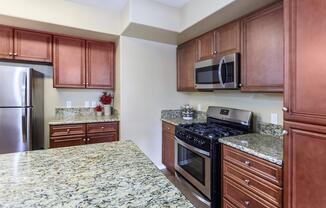 a modern kitchen with stainless steel appliances and wooden cabinets