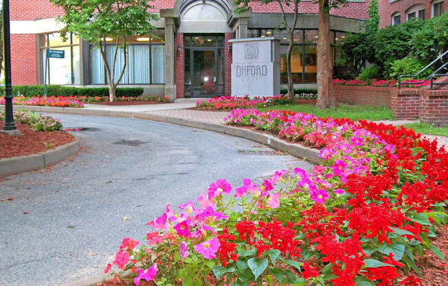 the entrance to a building with flowers in front of it