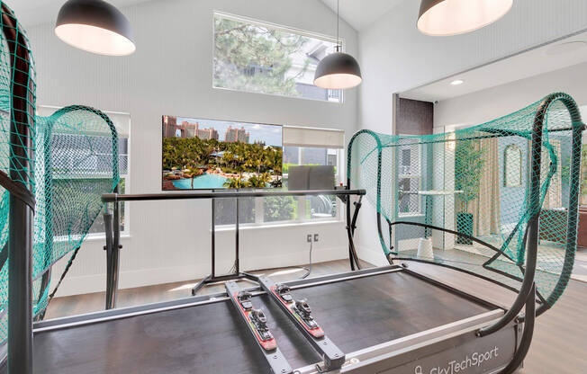 A trampoline room with a large window and a view of a cityscape.