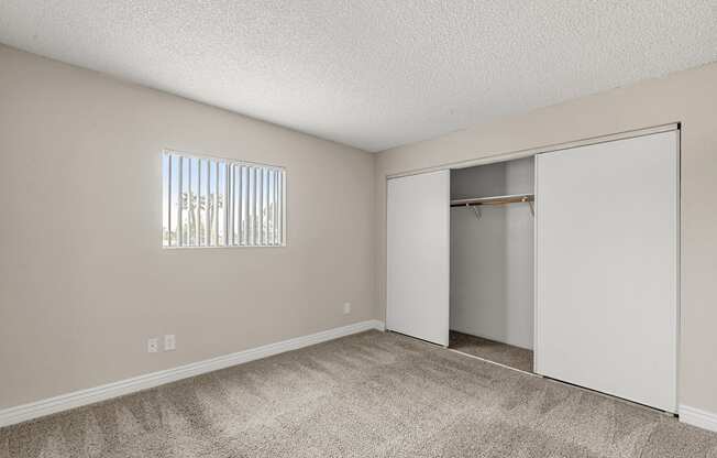 A room with a carpeted floor and a sliding door.