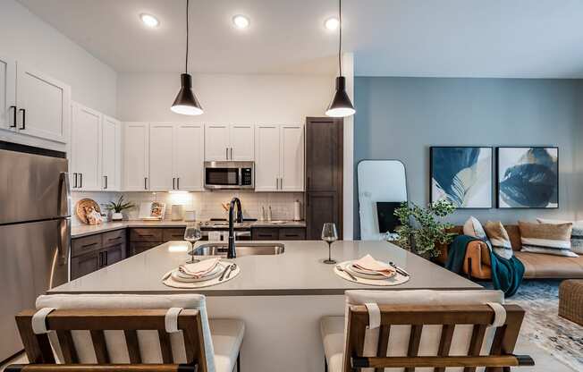 an open kitchen and living room with a table and chairs