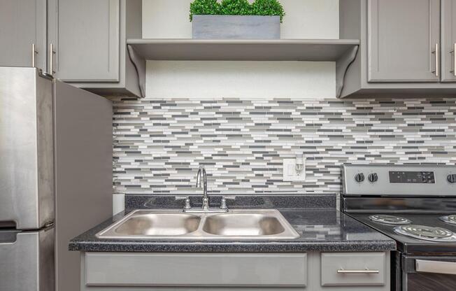 a stove top oven sitting inside of a kitchen