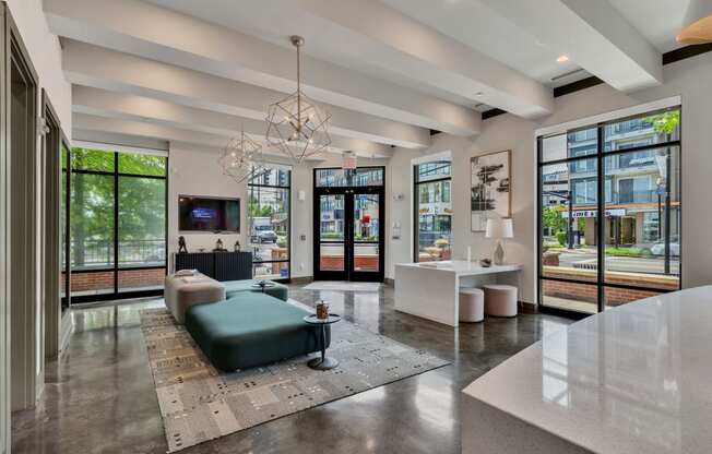a living room with a couch and a table and windows