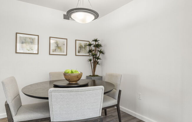 a room filled with furniture and vase on a table