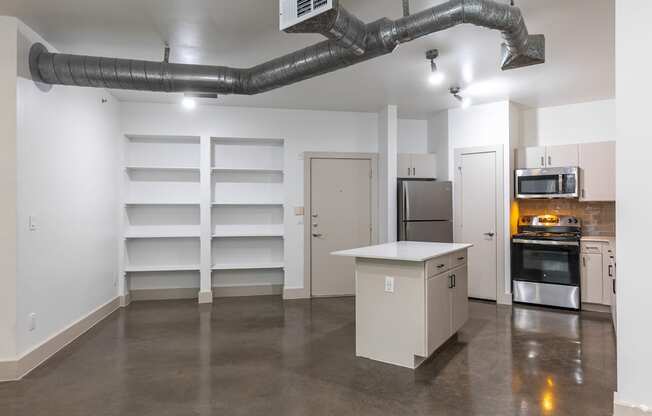 A kitchen area with a stove, oven, and sink.