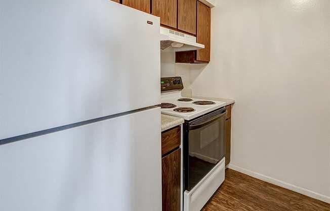 Apartment Kitchen at The Woods of Eagle Creek with white appliances