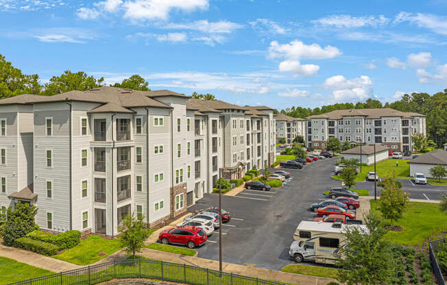 an aerial view of an apartment complex with a parking lot