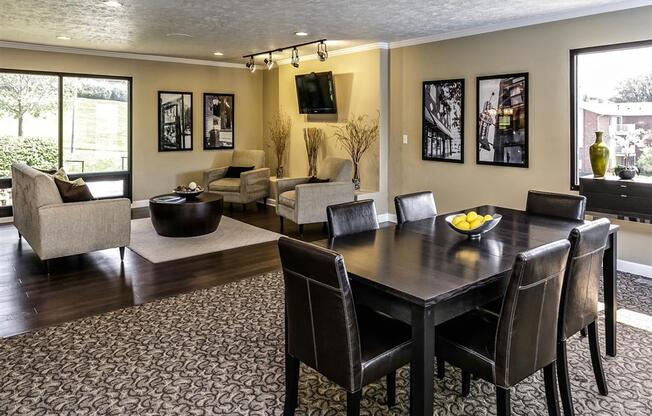 a dining room and living room with a table and chairs