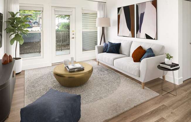 A living room with a white couch, a coffee table, and a painting on the wall.