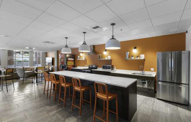 Resident Shared Kitchen Space with a long counter and chairs at Sedona Apartments, Seattle, WA