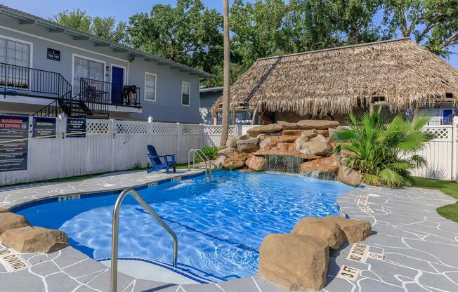 a house with a pool outside of a building