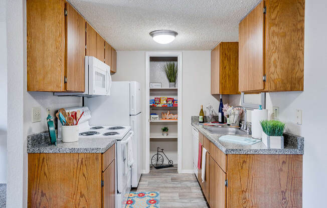 Kitchen with White Appliances and Pantry Closet
