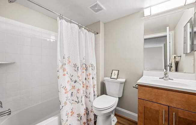 A white toilet sits next to a white sink in a bathroom.