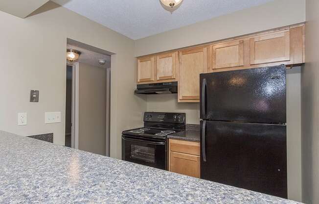 Kitchen with oven, refrigerator, and dishwasher