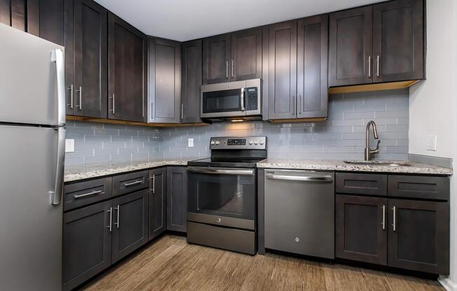 a kitchen with stainless steel appliances and wooden cabinets