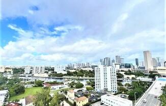 the view of the city from the balcony of a building