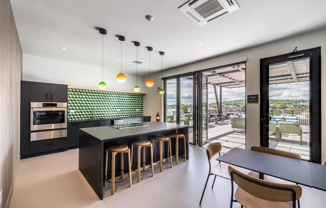 A modern kitchen with a bar area and a view of the outdoors.