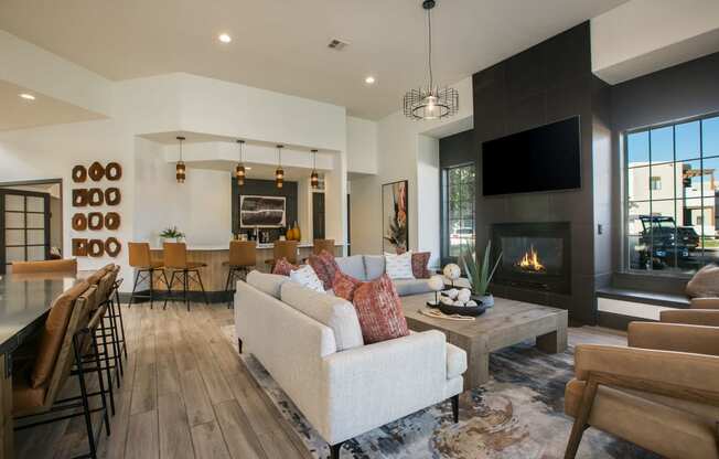 a living room with a couch and a table in front of a fireplace