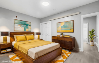 A bedroom with a large bed and two nightstands.