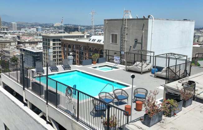 a swimming pool on the roof of a building with a city in the background