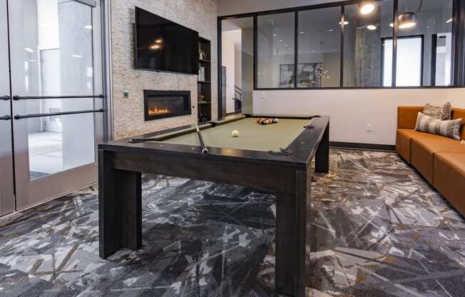 a pool table in the clubroom with a firepit