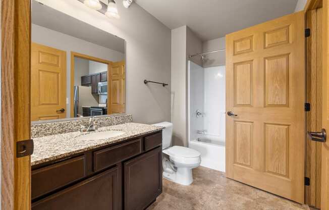 the ensuite bathroom at the enclave at woodbridge apartments in sugar land, tx