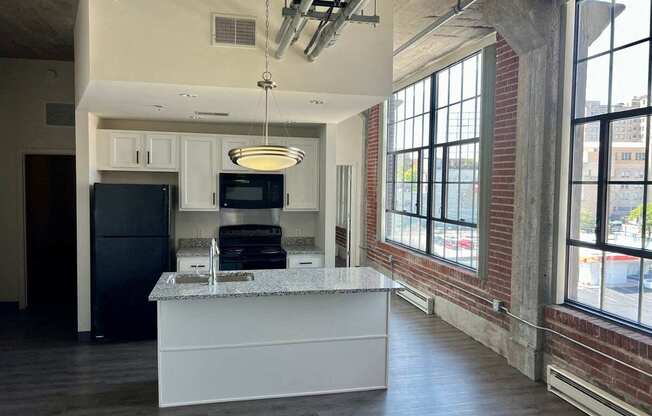 an open kitchen with a large window and a counter top in front of a kitchen