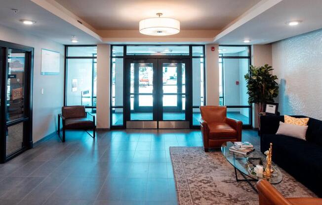 a lobby with a couch and chairs and a table at Barrington 101, Barrington, IL